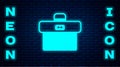 Glowing neon Briefcase icon isolated on brick wall background. Business case sign. Business portfolio. Vector