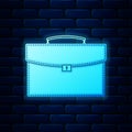 Glowing neon Briefcase icon isolated on brick wall background. Business case sign. Business portfolio. Vector