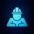 Glowing neon Builder icon isolated on brick wall background. Construction worker. Vector