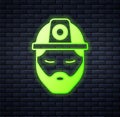 Glowing neon Builder icon isolated on brick wall background. Construction worker. Vector