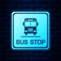 Glowing neon Bus stop icon isolated on brick wall background. Vector