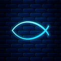 Glowing neon Christian fish symbol icon isolated on brick wall background. Jesus fish symbol Royalty Free Stock Photo