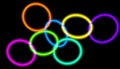 Glowing neon circles of different colors connected with each other. 3D rendered art. Royalty Free Stock Photo