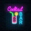 Glowing neon cocktails bar signboard on dark brick wall background. Luminous advertising sign of night club with bar.