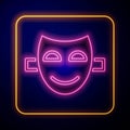 Glowing neon Comedy theatrical mask icon isolated on black background. Vector