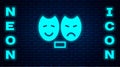 Glowing neon Comedy and tragedy theatrical masks icon isolated on brick wall background. Vector