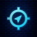 Glowing neon Compass icon isolated on brick wall background. Windrose navigation symbol. Wind rose sign. Vector