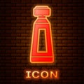 Glowing neon Cream or lotion cosmetic tube icon isolated on brick wall background. Body care products for men. Vector