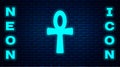 Glowing neon Cross ankh icon isolated on brick wall background. Egyptian word for life or symbol of immortality. Vector