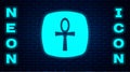 Glowing neon Cross ankh icon isolated on brick wall background. Egyptian word for life or symbol of immortality. Vector