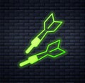 Glowing neon Dart arrow icon isolated on brick wall background. Vector