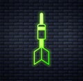 Glowing neon Dart arrow icon isolated on brick wall background. Vector