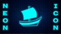 Glowing neon Egyptian ship icon isolated on brick wall background. Egyptian papyrus boat. Vector