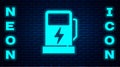 Glowing neon Electric car charging station icon isolated on brick wall background. Eco electric fuel pump sign. Vector Royalty Free Stock Photo