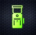 Glowing neon Electric coffee grinder icon isolated on brick wall background. Vector