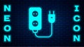 Glowing neon Electric extension cord icon isolated on brick wall background. Power plug socket. Vector Royalty Free Stock Photo