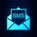 Glowing neon Envelope icon isolated on brick wall background. Received message concept. New, email incoming message, sms