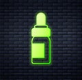 Glowing neon Essential oil bottle icon isolated on brick wall background. Organic aromatherapy essence. Skin care serum Royalty Free Stock Photo