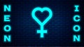 Glowing neon Female gender symbol icon isolated on brick wall background. Venus symbol. The symbol for a female organism