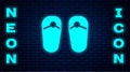 Glowing neon Flip flops icon isolated on brick wall background. Beach slippers sign. Vector Royalty Free Stock Photo