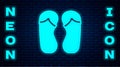 Glowing neon Flip flops icon isolated on brick wall background. Beach slippers sign. Vector Royalty Free Stock Photo