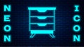 Glowing neon Furniture nightstand icon isolated on brick wall background. Vector