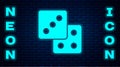 Glowing neon Game dice icon isolated on brick wall background. Casino gambling. Vector Royalty Free Stock Photo