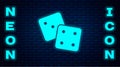 Glowing neon Game dice icon isolated on brick wall background. Casino gambling. Vector Royalty Free Stock Photo