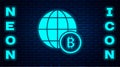 Glowing neon Globe and cryptocurrency coin Bitcoin icon isolated on brick wall background. Physical bit coin. Blockchain