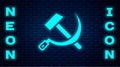 Glowing neon Hammer and sickle USSR icon isolated on brick wall background. Symbol Soviet Union. Vector Royalty Free Stock Photo