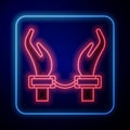 Glowing neon Handcuffs on hands of criminal man icon isolated on black background. Arrested man in handcuffs. A crime