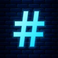 Glowing neon Hashtag icon isolated on brick wall background. Social media symbol. Modern UI website navigation. Vector Royalty Free Stock Photo