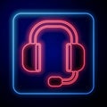 Glowing neon Headphones icon isolated on black background. Support customer service, hotline, call center, faq Royalty Free Stock Photo