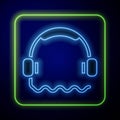 Glowing neon Headphones icon isolated on blue background. Support customer service, hotline, call center, faq Royalty Free Stock Photo