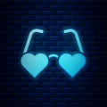 Glowing neon Heart shaped love glasses icon isolated on brick wall background. Suitable for Valentine day card design Royalty Free Stock Photo