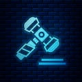 Glowing neon Judge gavel icon isolated on brick wall background. Gavel for adjudication of sentences and bills, court