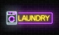 Glowing neon laundry signboard on dark brick wall background. Illuminated self-service washhouse.