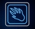 Glowing neon line Alligator crocodile paw footprint icon isolated on brick wall background. Vector
