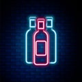 Glowing neon line Bottles of wine icon isolated on brick wall background. Colorful outline concept. Vector