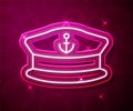 Glowing neon line Captain hat icon isolated on red background. Vector
