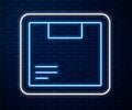 Glowing neon line Carton cardboard box icon isolated on brick wall background. Box, package, parcel sign. Delivery and Royalty Free Stock Photo