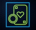 Glowing neon line Casino chip and playing cards icon isolated on brick wall background. Casino poker. Vector Royalty Free Stock Photo