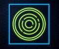 Glowing neon line Checker game chips icon isolated on brick wall background. Vector