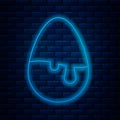 Glowing neon line Chocolate egg icon isolated on brick wall background. Vector