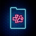 Glowing neon line Clipboard with medical clinical record pet icon isolated on brick wall background. Health insurance