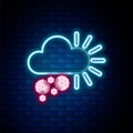 Glowing neon line Cloudy with snow icon isolated on brick wall background. Cloud with snowflakes. Single weather icon