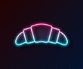 Glowing neon line Croissant icon isolated on black background. Vector