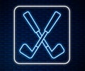 Glowing neon line Crossed golf club icon isolated on brick wall background. Vector