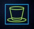 Glowing neon line Cylinder hat icon isolated on brick wall background. Vector