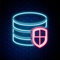 Glowing neon line Database protection icon isolated on brick wall background. Secure database icon. Colorful outline